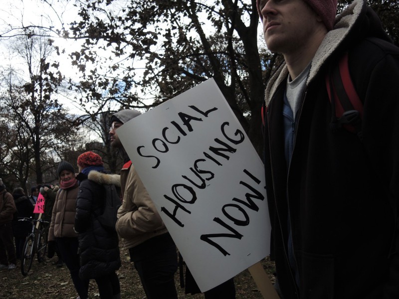 A person holds a sign that says