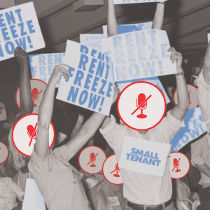 A historical black and white image of a number of people protesting at an assembly, some with signs around their necks that say